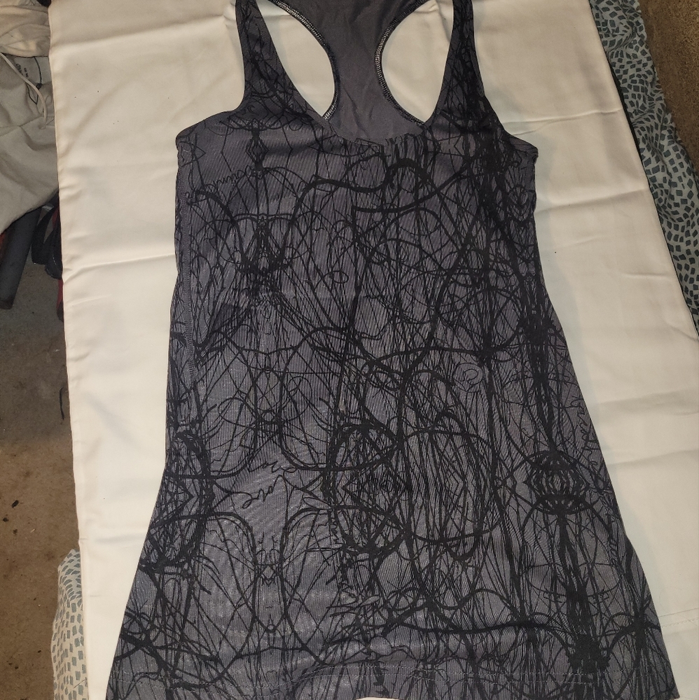 Lulelemon InStill tank in Grey with white detail. Size 6